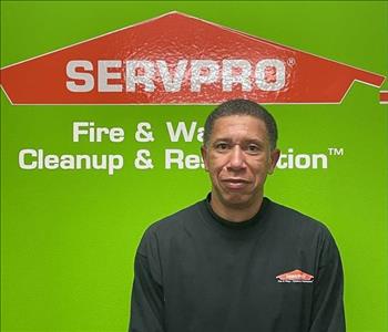 Eric with a green servpro background