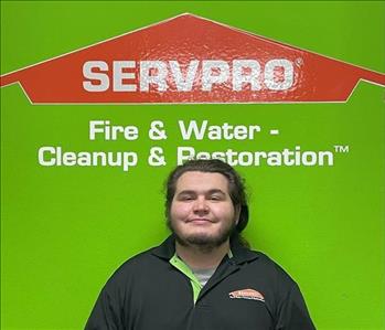 Kyle with a green servpro background