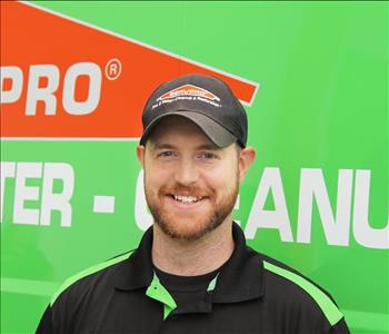 Nick M with a green servpro background