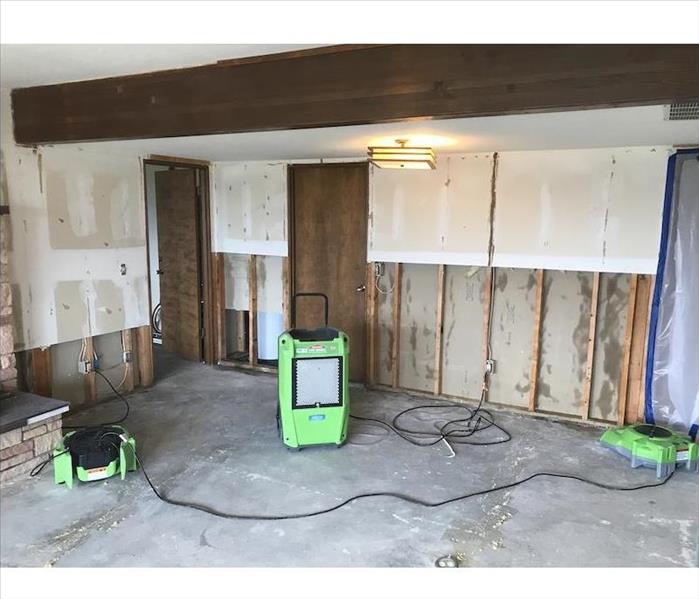 Room with concrete floor and sheetrock with flood cuts